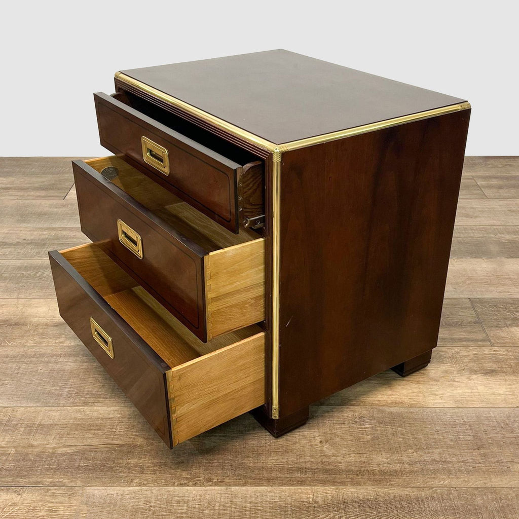 2. Open drawers of a Reperch three-drawer nightstand showing wood interior, with brass trim from a side angle.