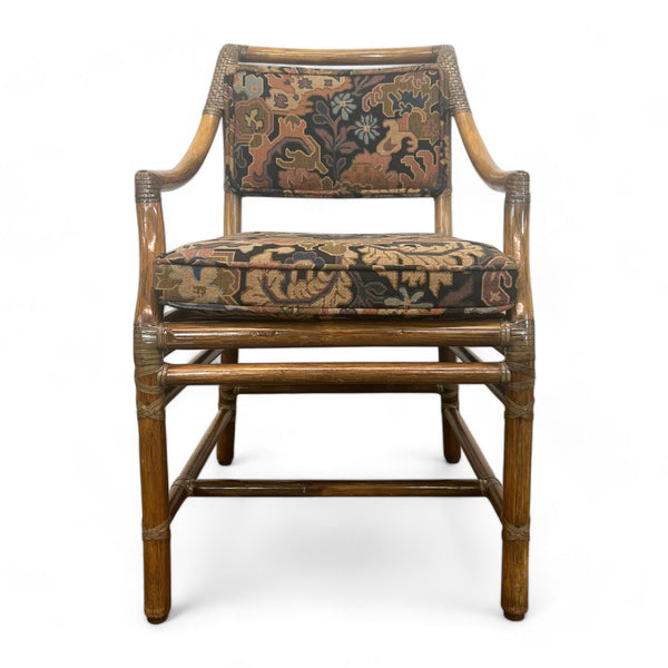 Vintage McGuire dining chair with bamboo frame and patterned cushions.