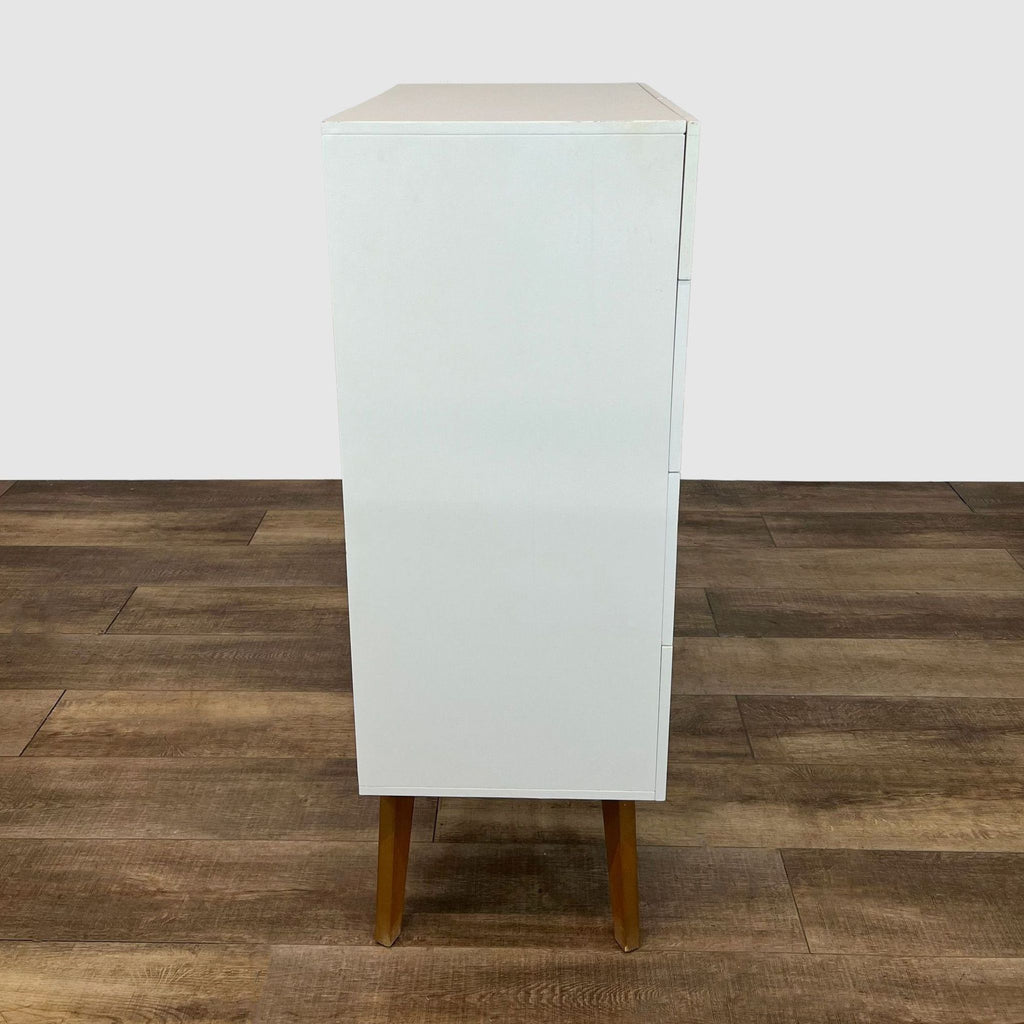 Profile view of West Elm highboy dresser on wooden legs.