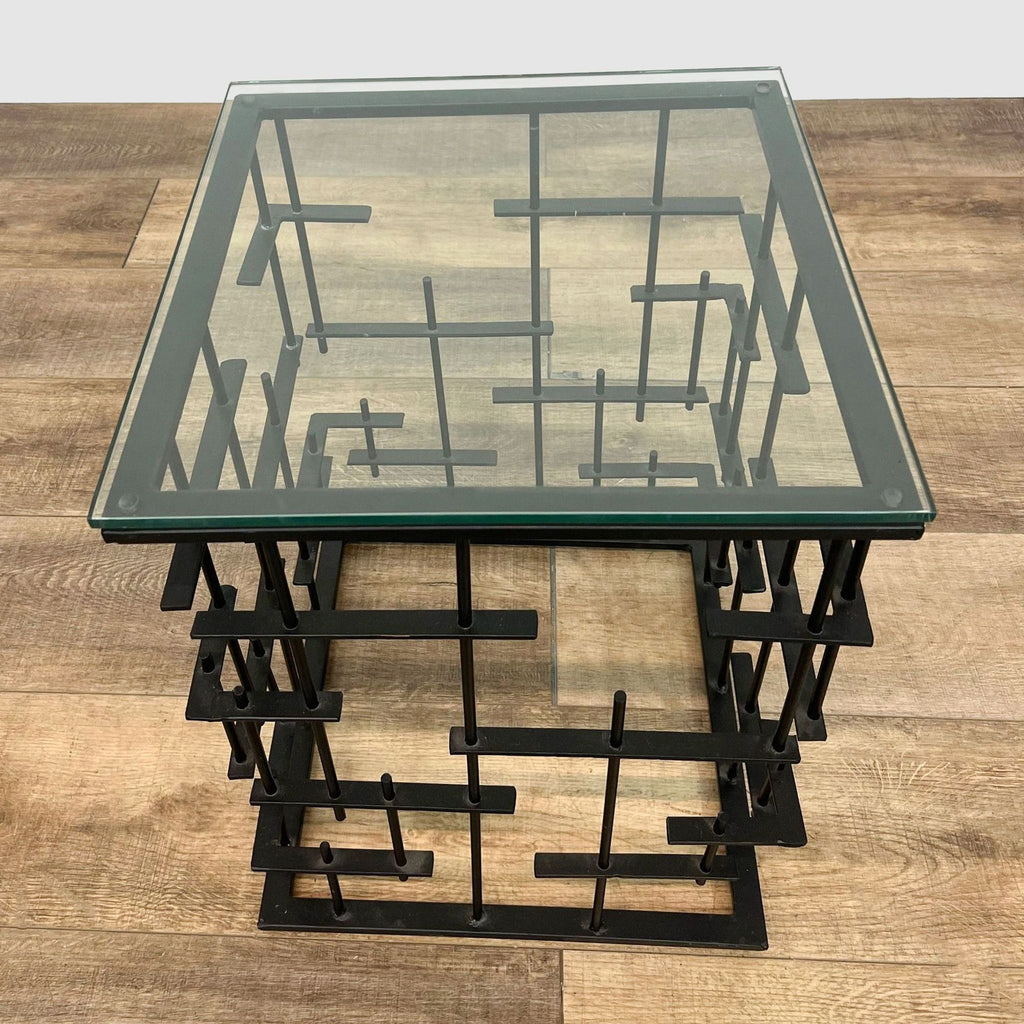 Angular view of Reperch modern console table featuring a geometric metal structure and glass surface.
