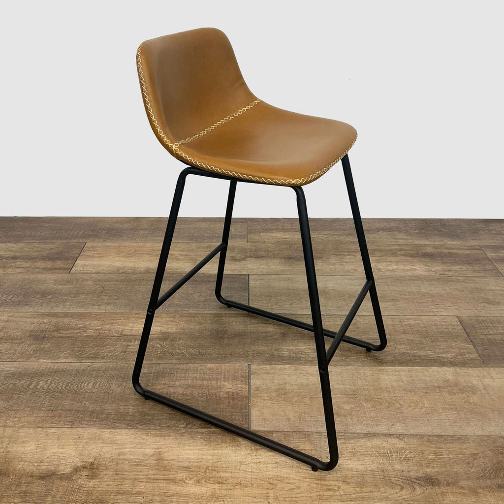 Side view of Amazon leather-look stool with contrast stitching and sturdy metal legs. 