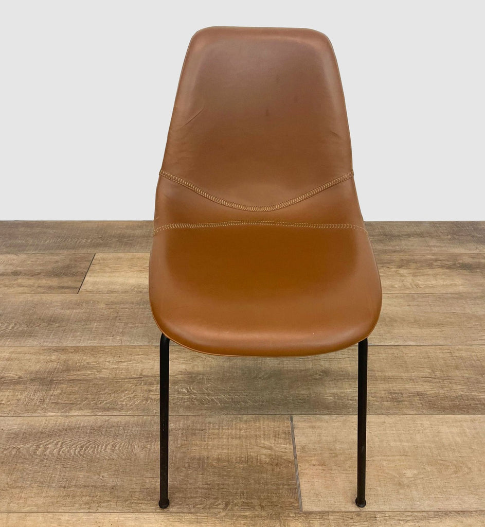 1. Reperch brown faux leather dining chair with straight-on view, showcasing black metal legs on a wooden floor.