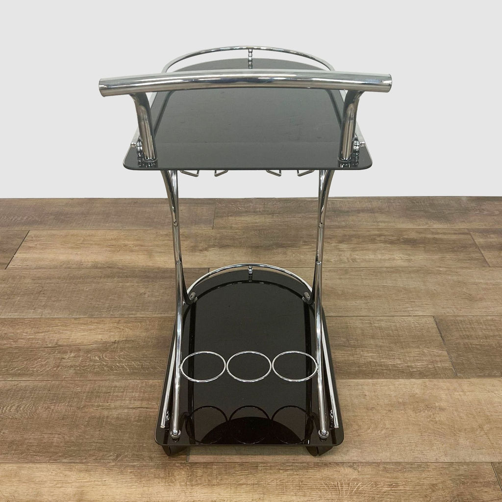 Modern Orren Ellis bar cart with three bottle holders at the base and a glass storage shelf, in a front-facing view.