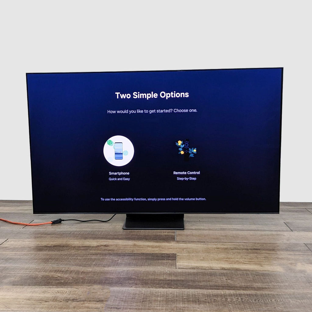 Samsung OLED TV displaying setup options on a wood floor, highlighting smart integration and ease of setup.