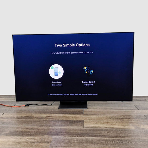 Samsung OLED TV displaying setup options on a wood floor, highlighting smart integration and ease of setup.