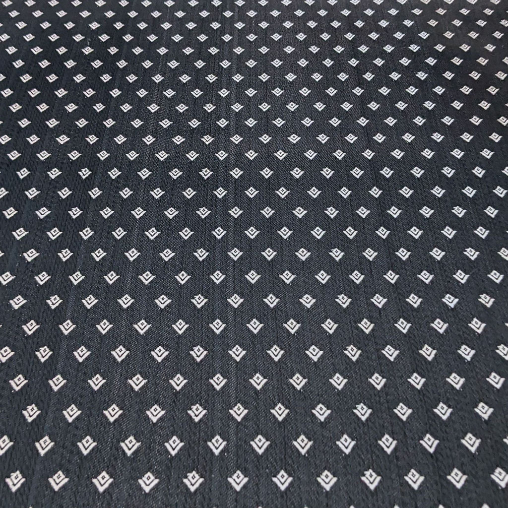 3. Close-up texture of a Sankheda chair fabric by Reperch, displaying a geometric pattern in black and silver lacquer finish.