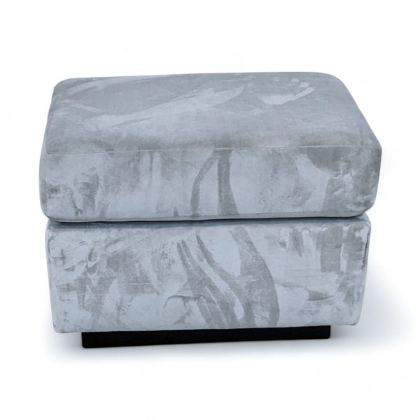 1. "West Elm contemporary gray ottoman with dark finished wood frame against a white background."