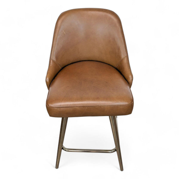 a pair of chairs in brown leather