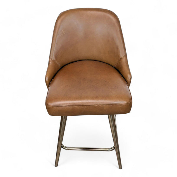 1. "West Elm nut saddle leather swivel stool with a curvy seat on a shiny metal frame."