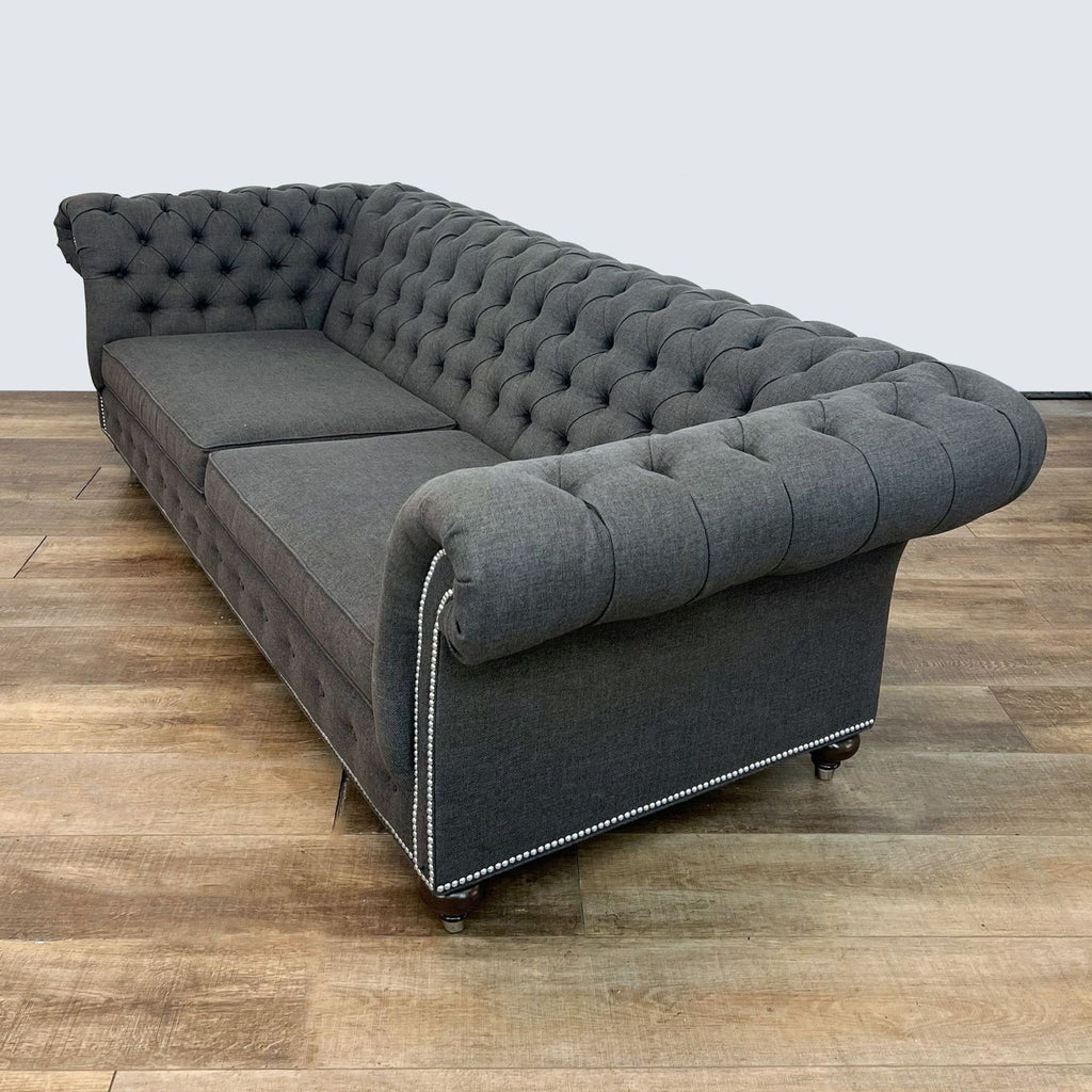 2. Angled view of the Mansfield 3-seat Ethan Allen sofa revealing its tufted back, rolled arm, and side profile.