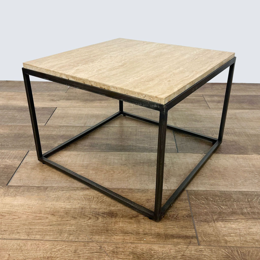 2. Single square Reperch coffee table with beige wooden surface and sturdy black metal framework, showcased on a wooden floor.