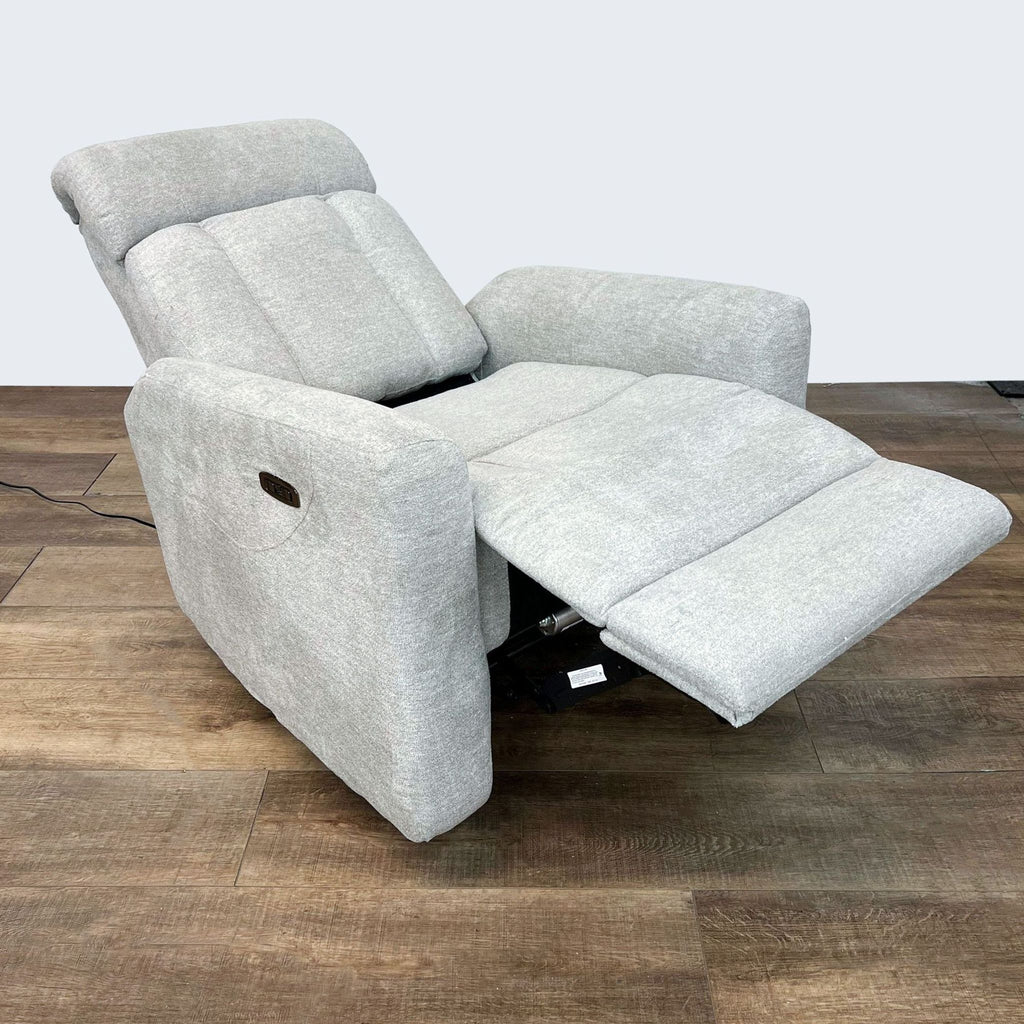2. Living Spaces Halo II grey power recliner with extended footrest and adjustable headrest, highlighting its reclining capabilities.