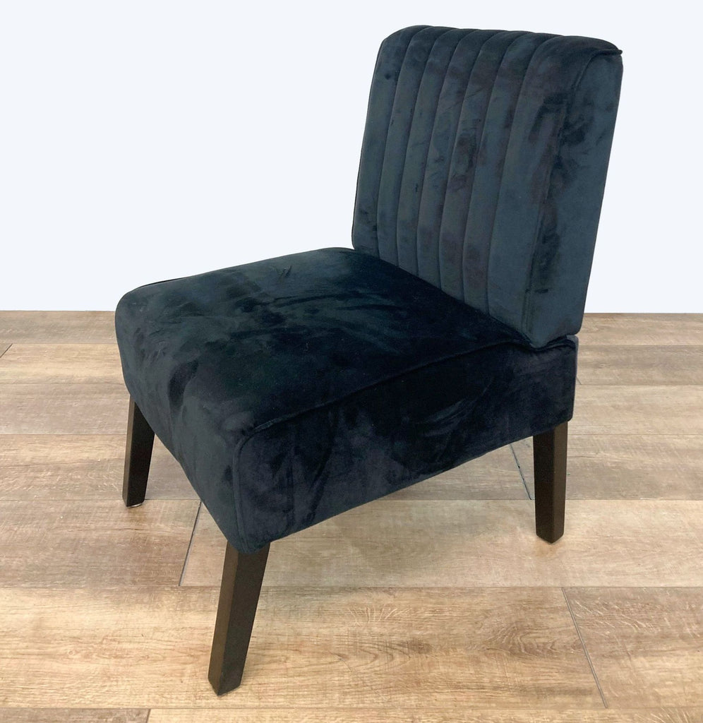 Close-up of channel tufting on the black velvet upholstery of the Evans Slipper Chair.