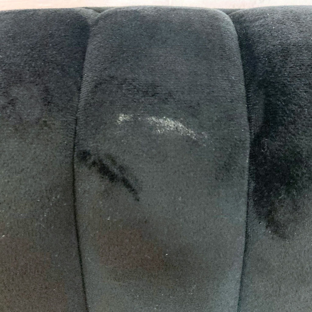 Side view of the Evans Slipper Chair, showcasing its elegant black velvet and wood legs.