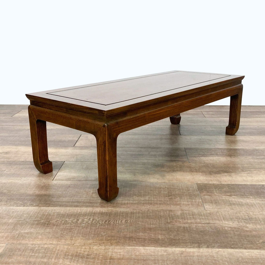 Elegant Reperch coffee table, showcasing a rich wood finish on a wooden floor.