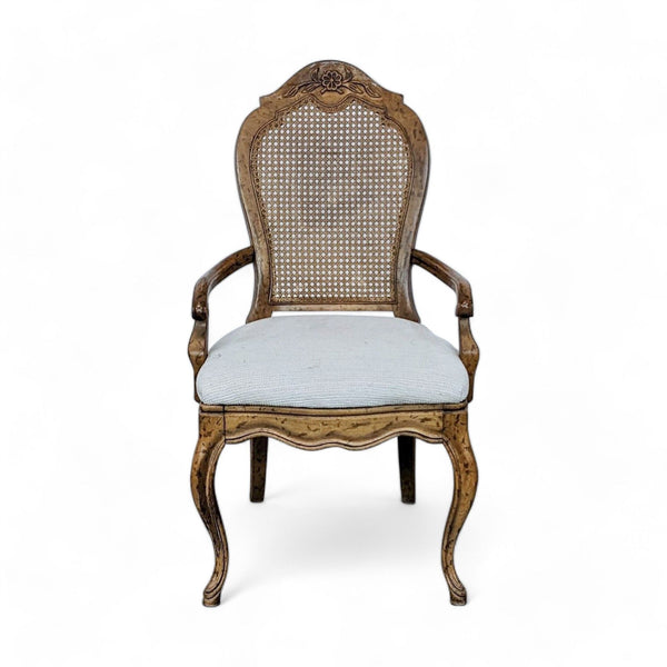 1. Louis XV style Reperch dining chair with detailed wood carving, cane back, and light upholstered seat on a white background.