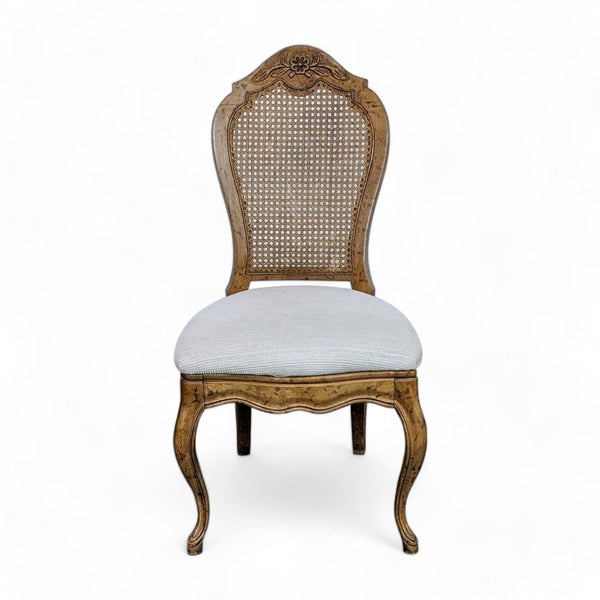 1. Louis XV style Reperch dining chair with carved wood details and cane back, upholstered seat on white background.