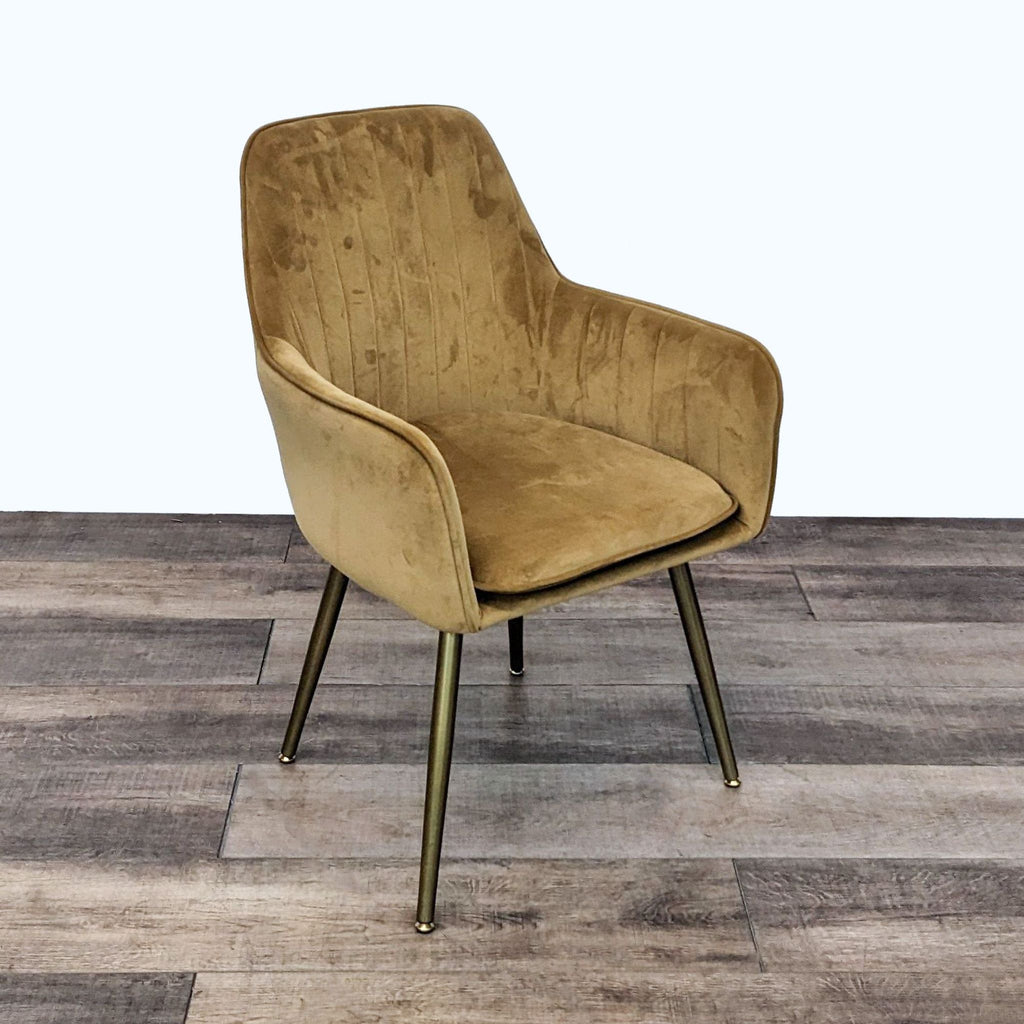 Gold velvet upholstered Reperch dining chair with a Mid-Century modern design, showcasing channel tufting and angled wooden legs.