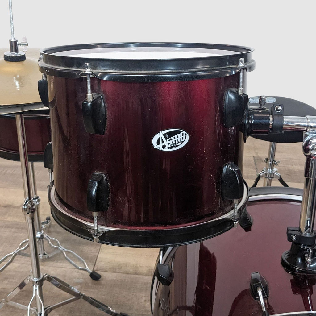 3. Detailed view of a wine red tom drum from the Astro Drums set, highlighting the shiny finish and branding.
