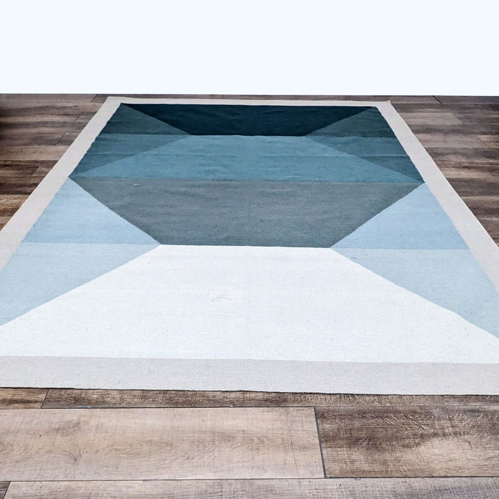Tofino 8’x10’ rug with teal and grey geometric patterns by EQ3.