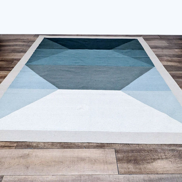 Tofino 8’x10’ rug with teal and grey geometric patterns by EQ3.