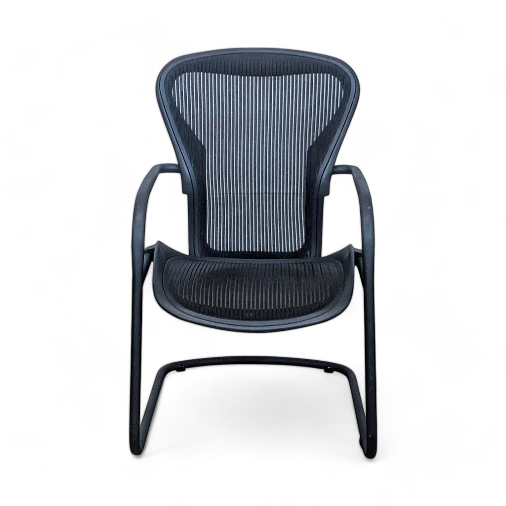 1. Herman Miller Aeron Side Chair with black Pellicle suspension and a sling base, viewed from the front.