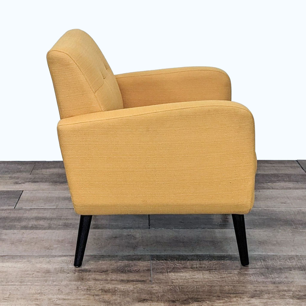 Alt text 2: Side view of a mustard yellow Handy Living lounge chair, showcasing its mid-century design with a curved side profile and black tapered legs.