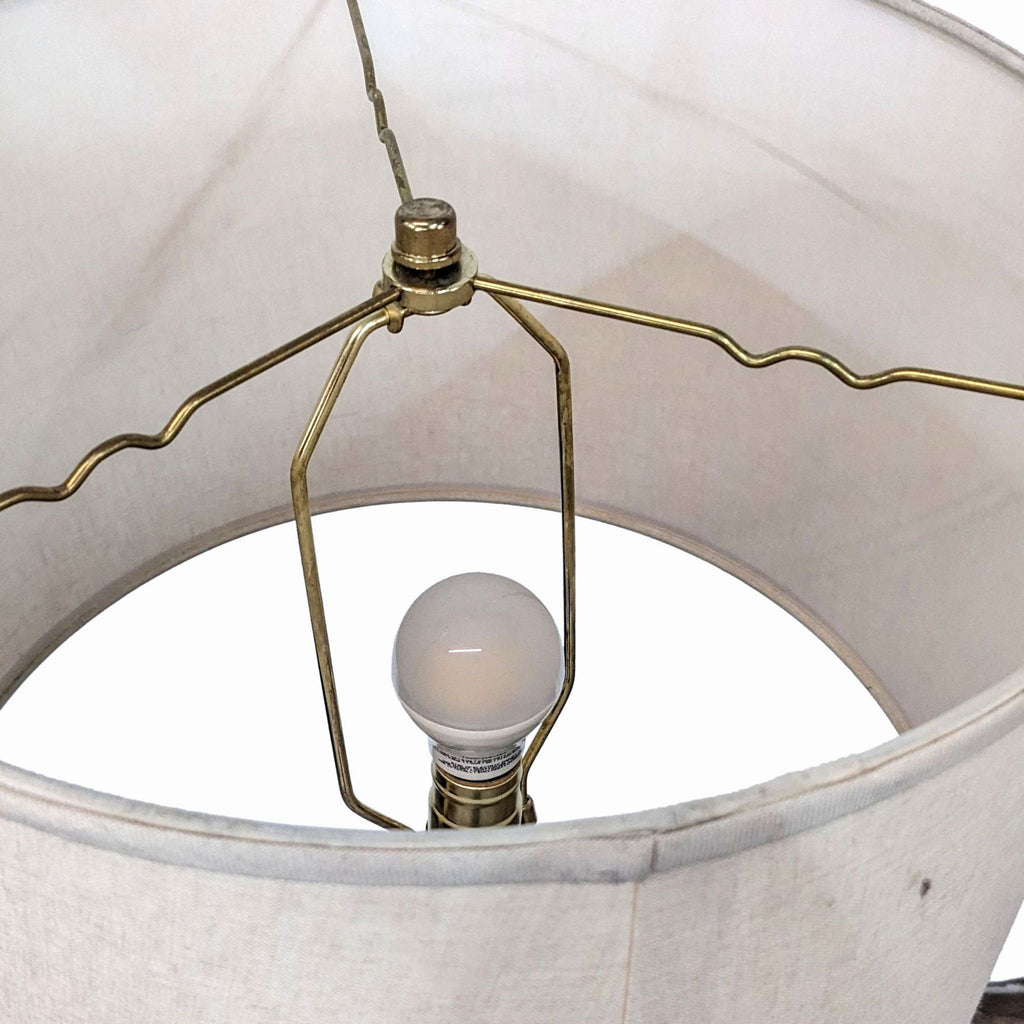 Close-up of the Reperch lamp's bulb and brass fixture inside the drum shade.  