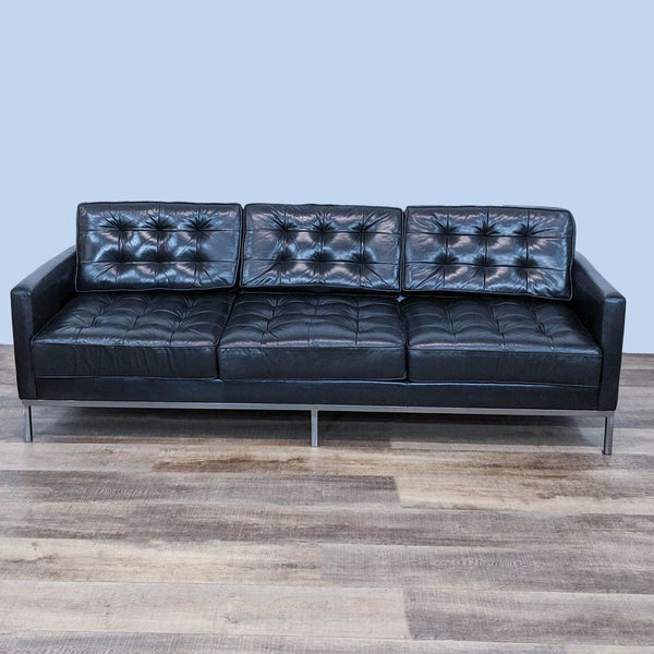 Alt text 1: A front view of a Thrive Furniture Florence three-seat sofa with polished chrome frame, black leather upholstery, and button tufting.