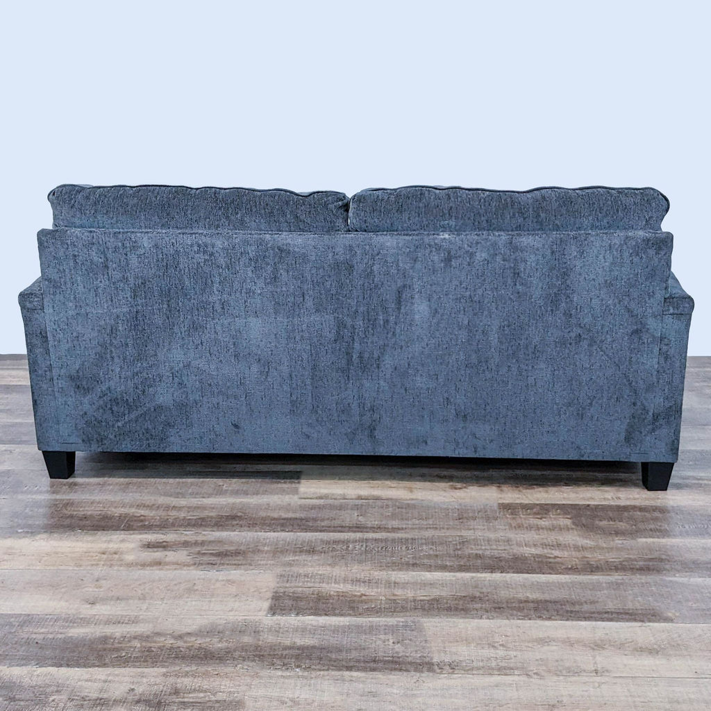 Rear view of an Ashley Furniture Abinger loveseat with a contemporary design and textured chenille fabric.