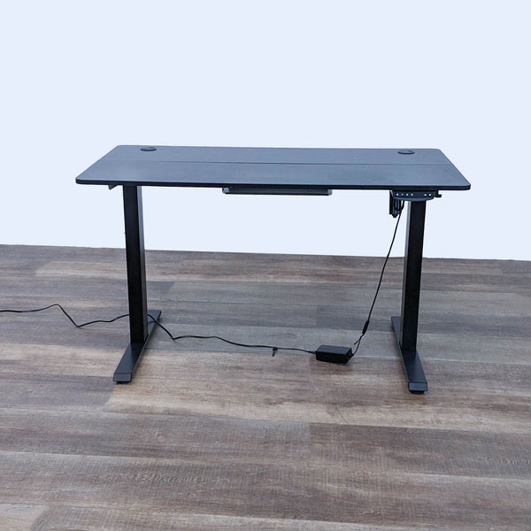 Fezibo height-adjustable desk at its maximum height of 47.5 inches, showing control pad and power cords.