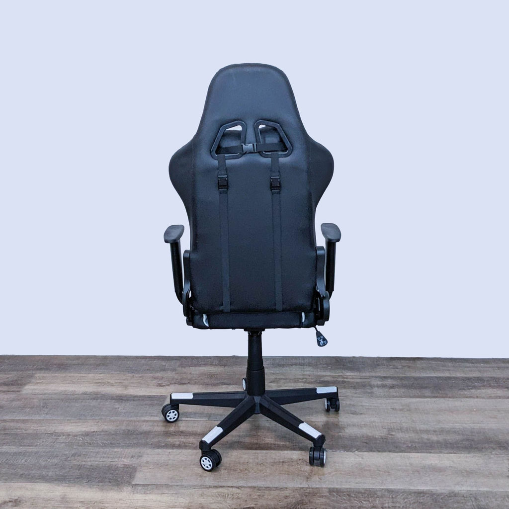 Rear perspective of Homall black and white gaming chair with distinctive backrest design, adjustable components, and swivel wheels.