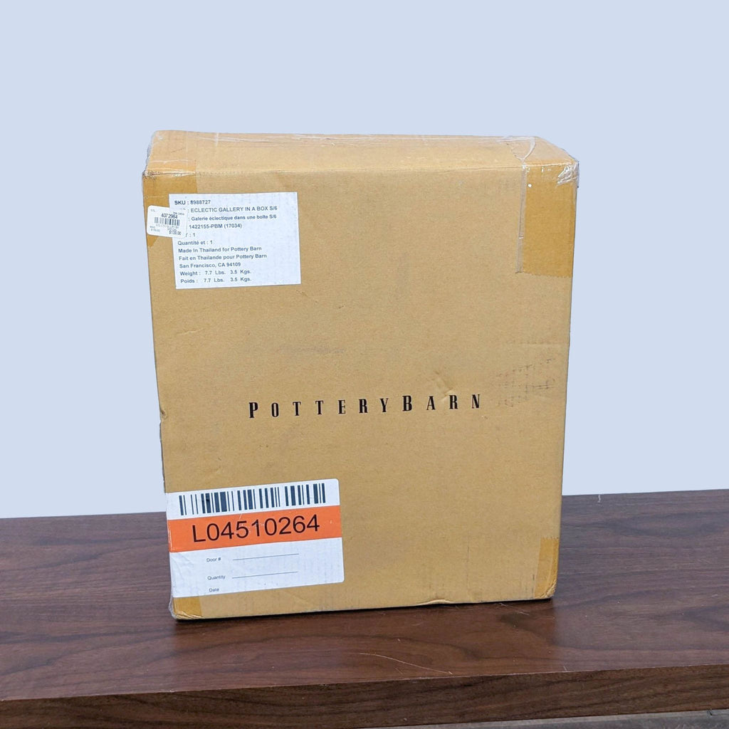 2. Brown Pottery Barn cardboard box with company name and shipping label on a wooden surface.