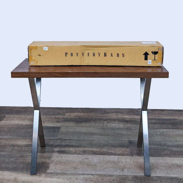 1. "Pottery Barn Rustic Wood Lodge console table with metal X brace legs and packaged tabletop on top."