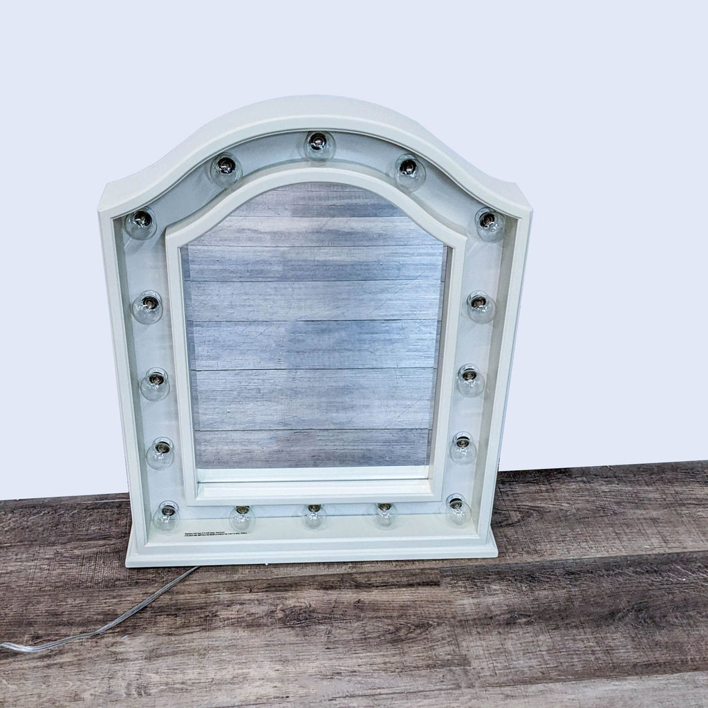 Arched wooden framed Hannah mirror by Pottery Barn Teen, featuring glass bulbs, placed against a white background.