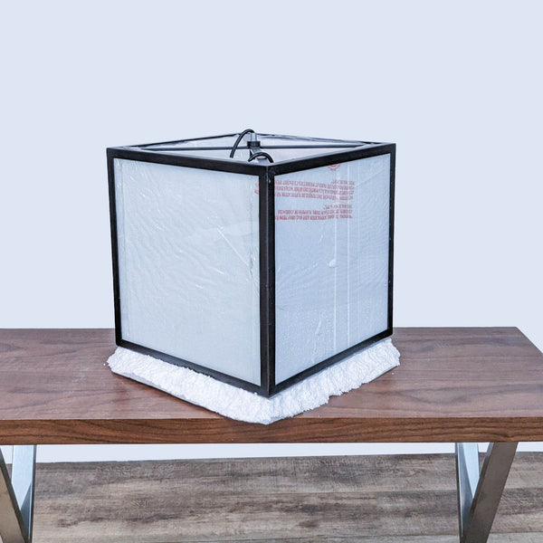 Reperch lighting fixture in original packaging on a wooden table.