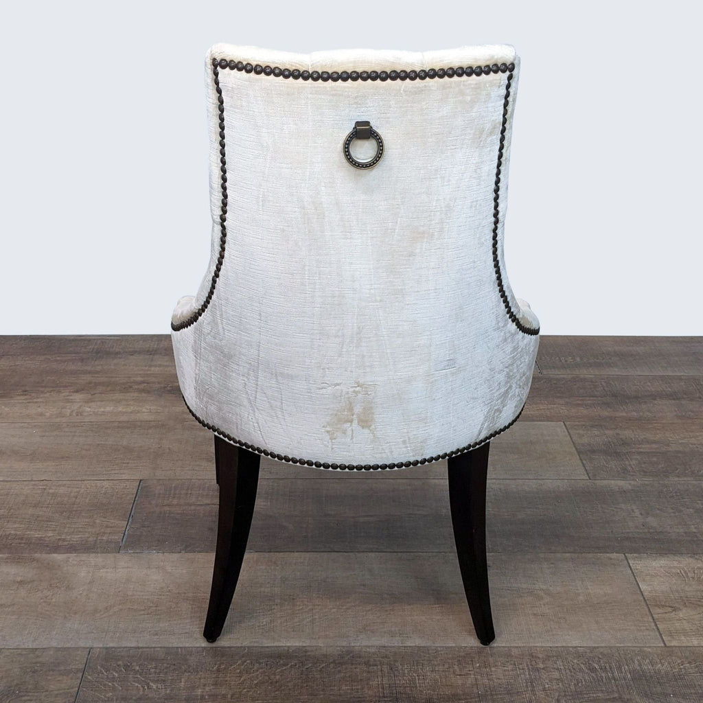 Alt text 3: Rear view of a Baker designed dining chair by Thomas Pheasant with ring pull and metal tag.