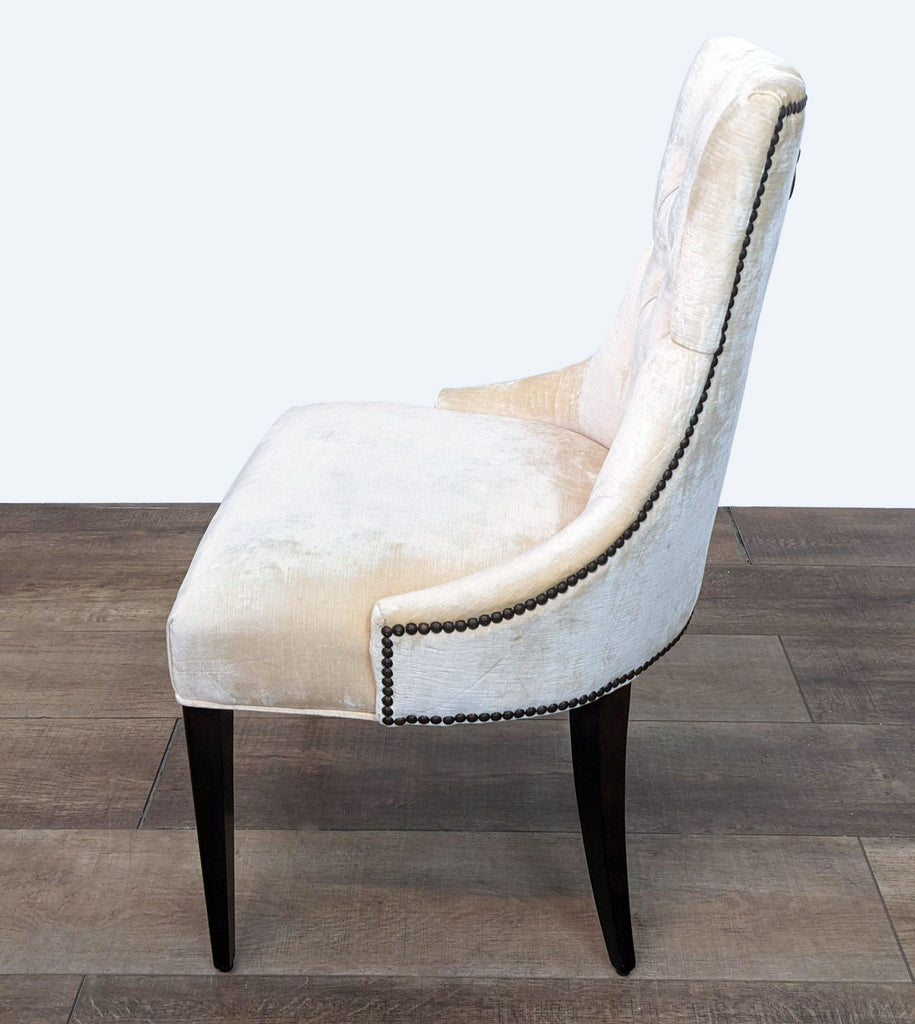 Alt text 2: Side view of Baker Ritz dining chair showing nailhead detail and sleek wooden legs on wood floor.