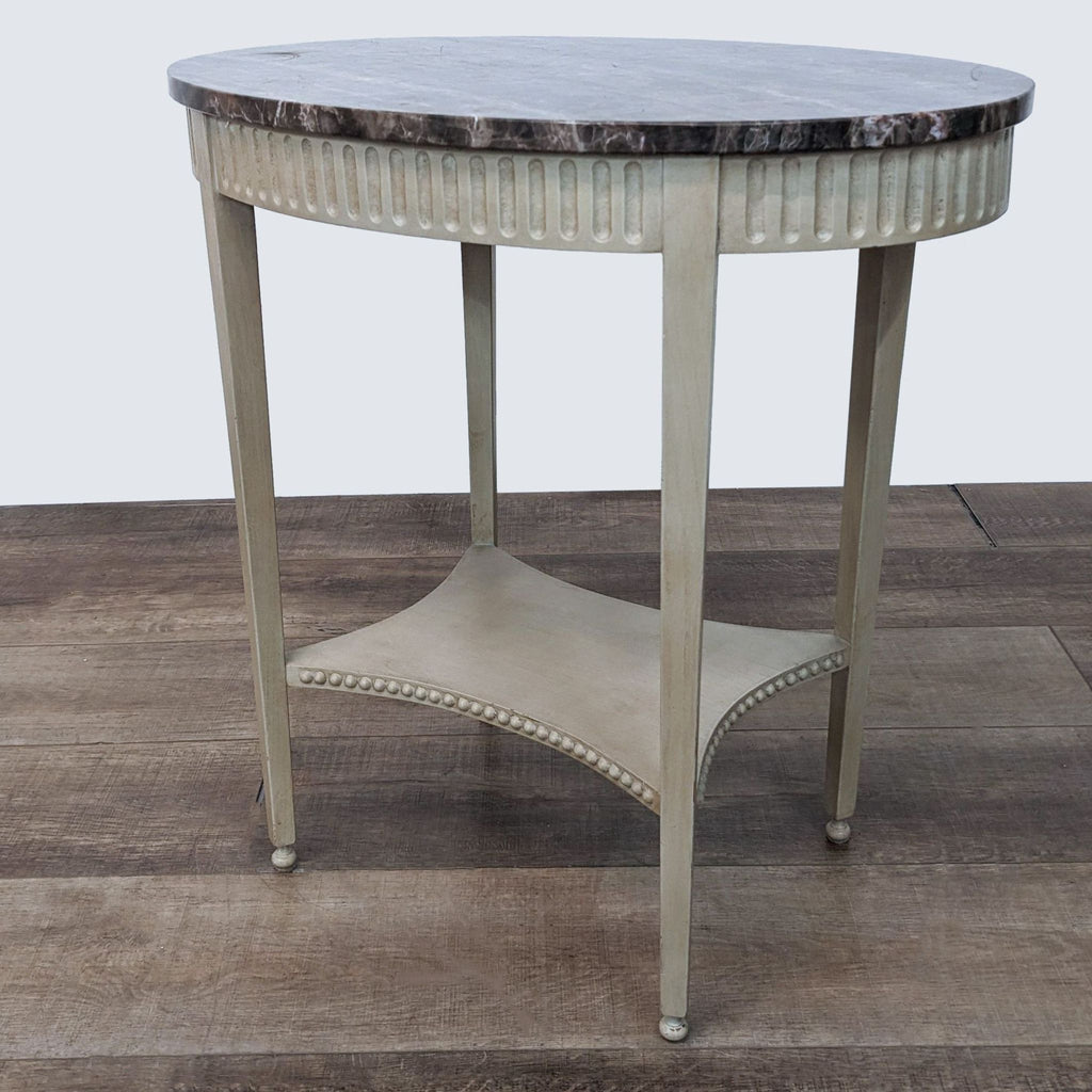 Angle view of a Reperch end table featuring a marble top and elegant wooden frame with metal foot caps on wood flooring.