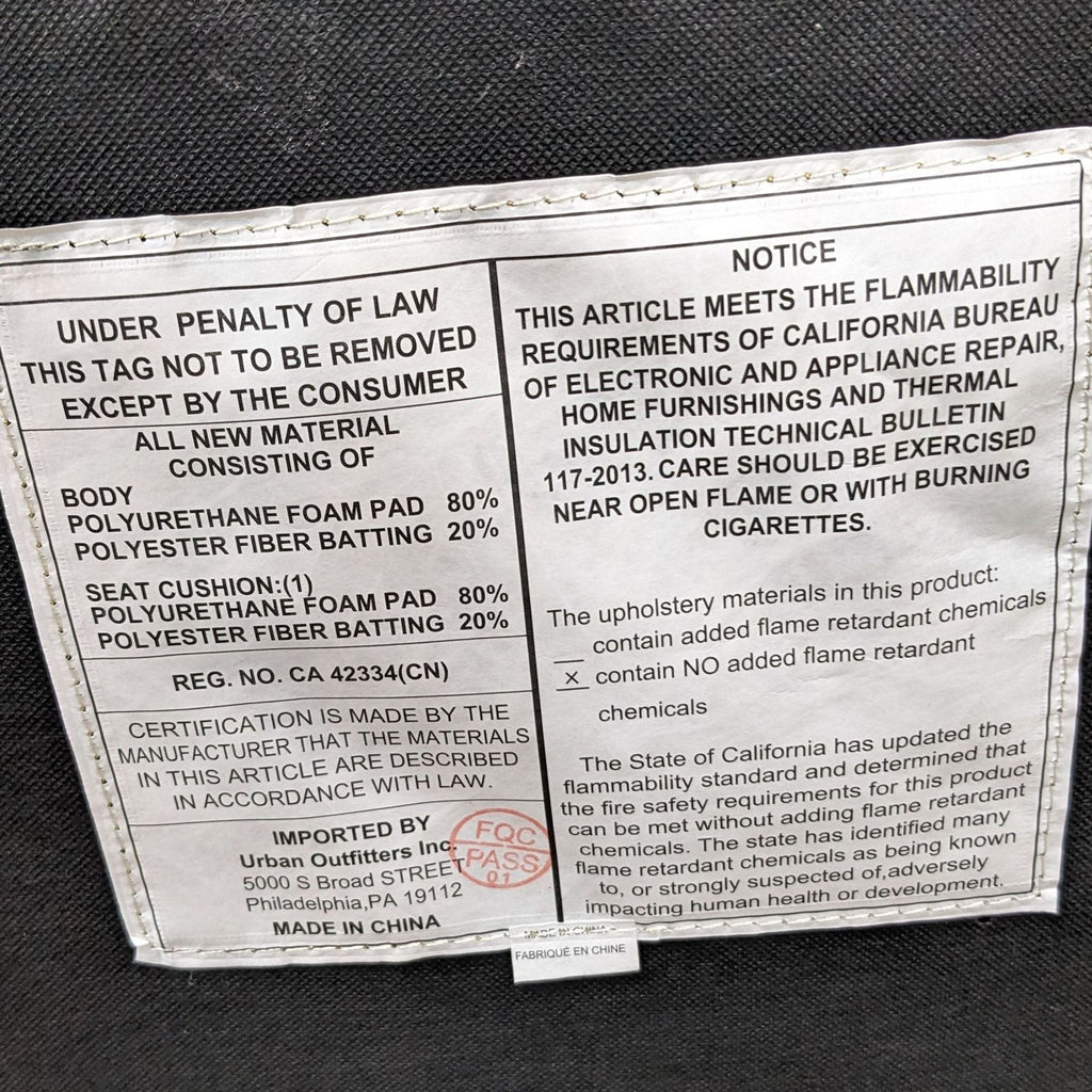 3. "Care label of Urban Outfitters Marisol chair detailing the materials and legal notices, including flammability standards."