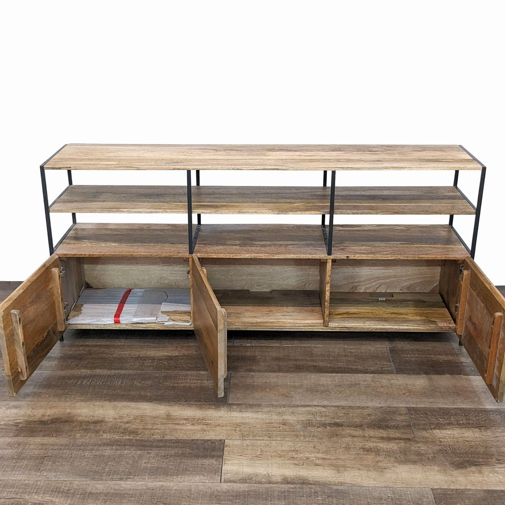 Open West Elm wooden entertainment center with storage compartments displayed.