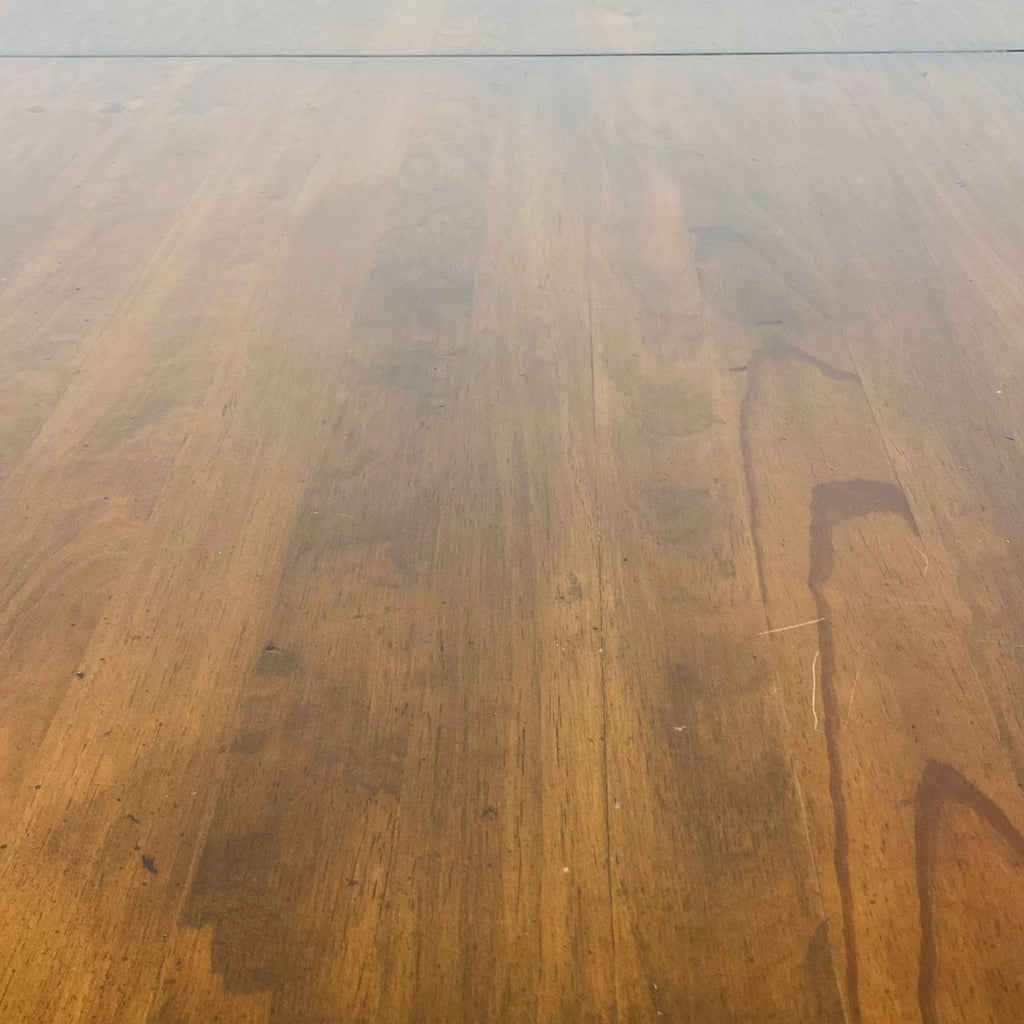 a large, solid, and highly polished, solid wood dining table.