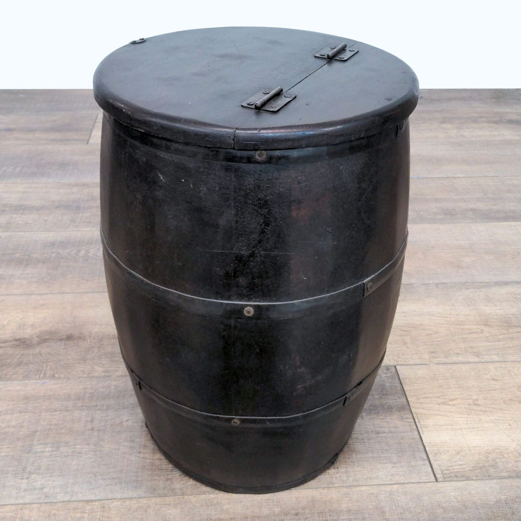 3. "A Reperch dark wooden barrel, vintage design with lid shut, positioned on wood-patterned flooring."