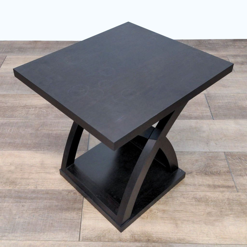 Modern black square Wayfair end table with unique geometric base design.