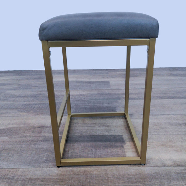 Grey upholstered backless stool with gold metal frame by Reperch, dimensions 18x15x23 inches.