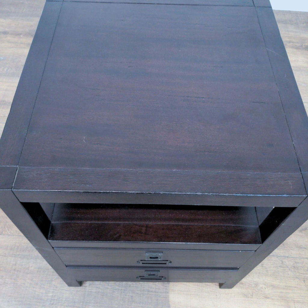 Top view of a dark wood end table with a smooth, flat surface.