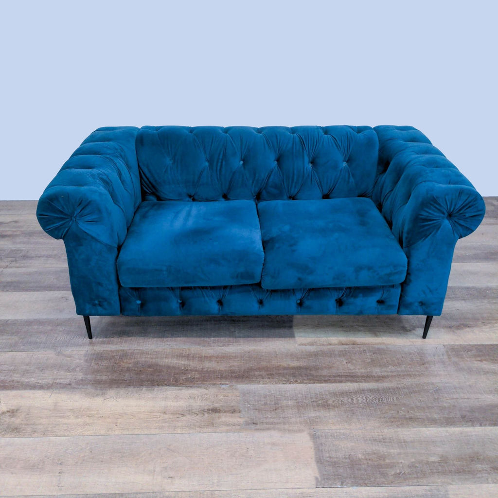 1. "Reperch brand tufted blue velvet loveseat viewed from the front, showcasing the deep upholstery and tapered legs."