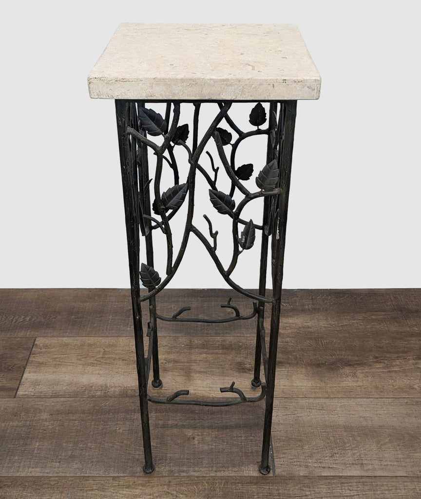 1. Reperch brand wrought iron table with intricate leaf design on base and square marble top.