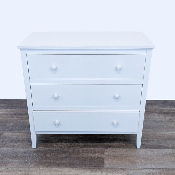 1. Emerson 3-drawer white dresser from Pottery Barn Kids, shown from the front, featuring round knobs on a wood floor.