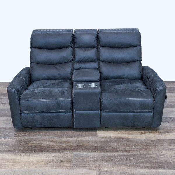 1. Front view of a Living Spaces Malia power reclining loveseat, featuring a storage console, cup holders, and a luxurious dark fabric.